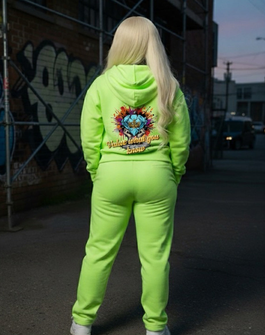 Value What You Know ￼- HOODIE in neon green worn by model, showcasing bold graphic design on the back in urban setting.