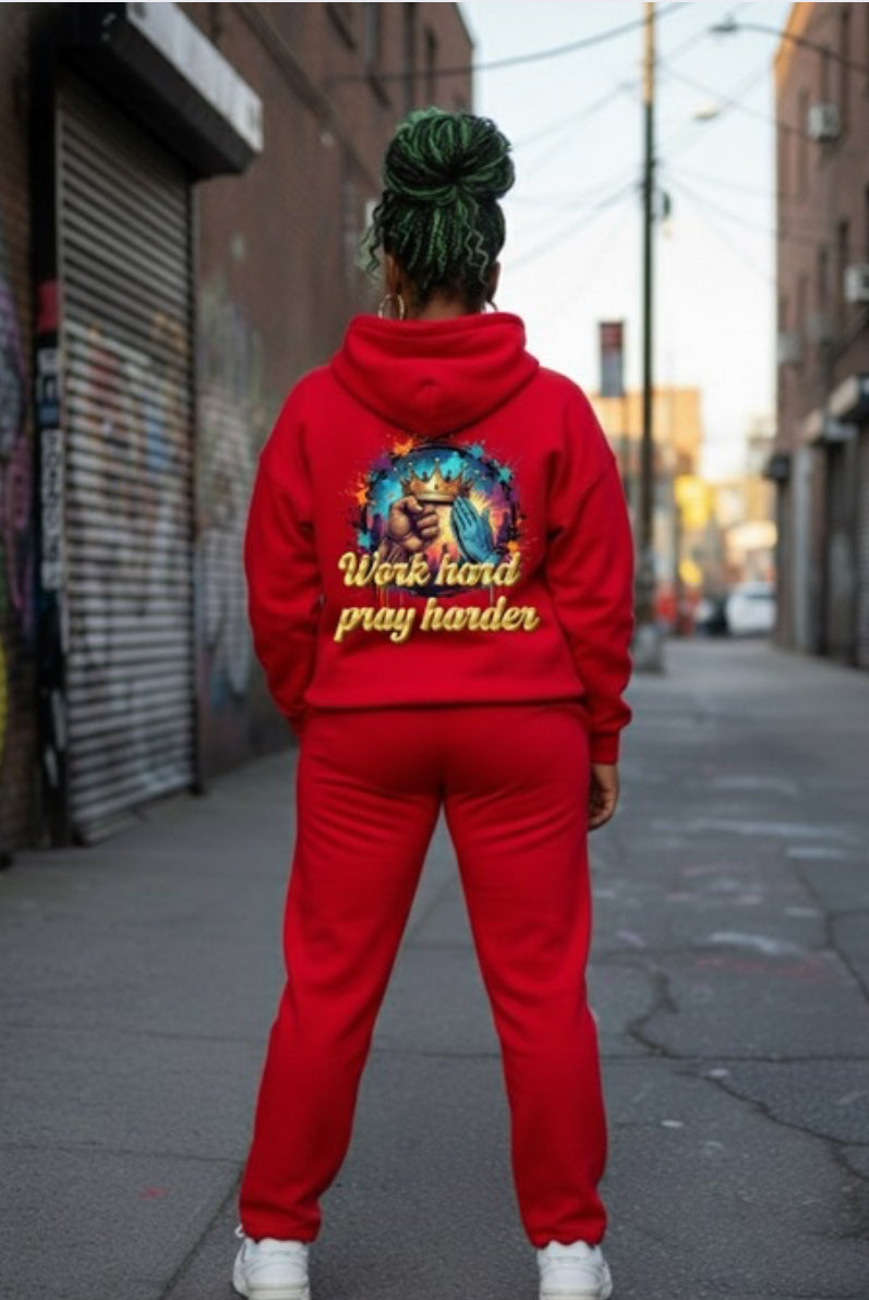 Person wearing red Work Hard- HOODIE on the street showcasing stylish streetwear and vibrant design.