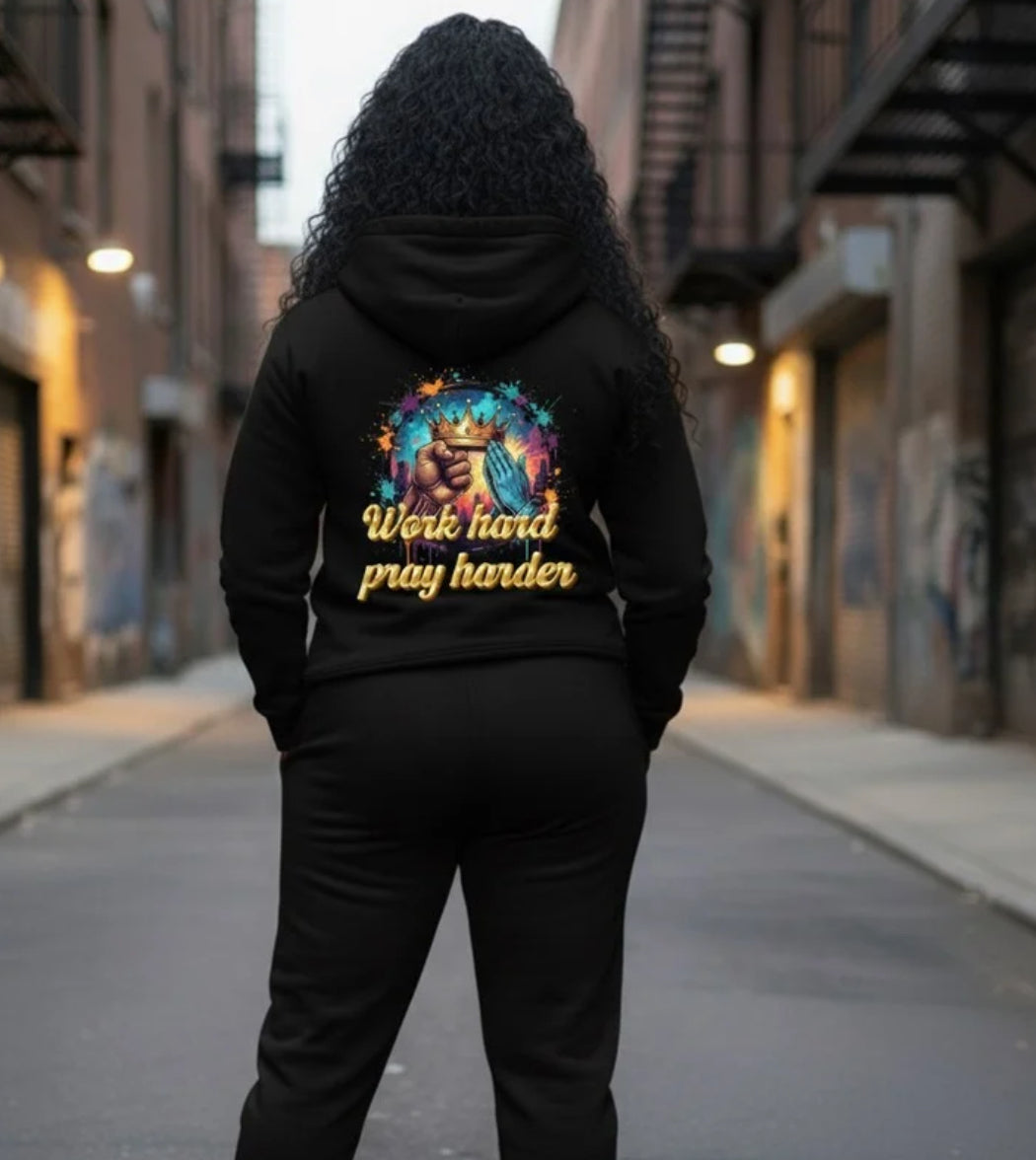 Back view of a person wearing a Work Hard- HOODIE, showcasing vibrant graphic design in a street scene.