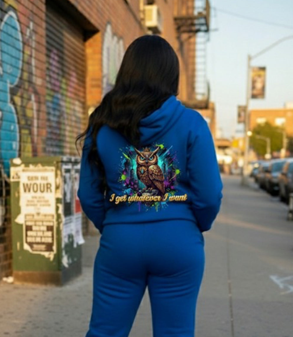 Woman wearing blue Whatever I Want- HOODIE featuring owl design in urban setting, emphasizing streetwear style.