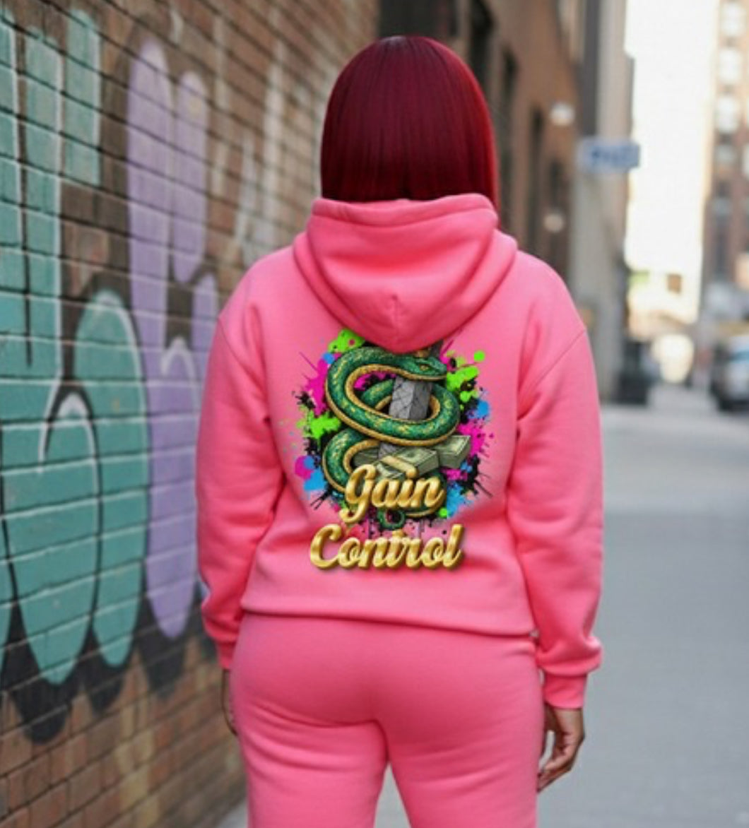 Model wearing Gain Control- HOODIE in pink, showcasing streetwear style and vibrant graphic design.