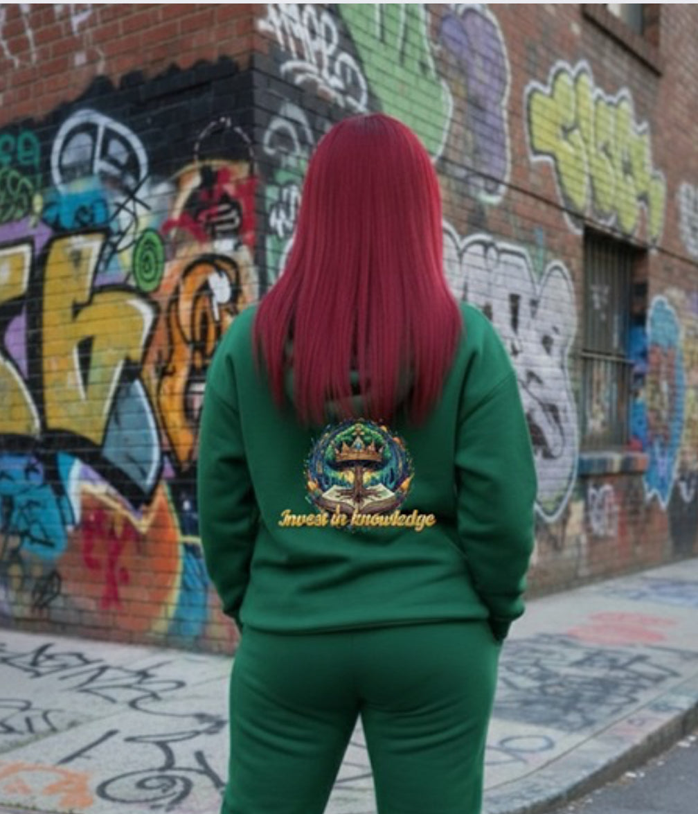 Invest In Knowledge- HOODIE worn by model in front of vibrant street art, showcasing Crown Hustle Fleece Pullover Streetwear.