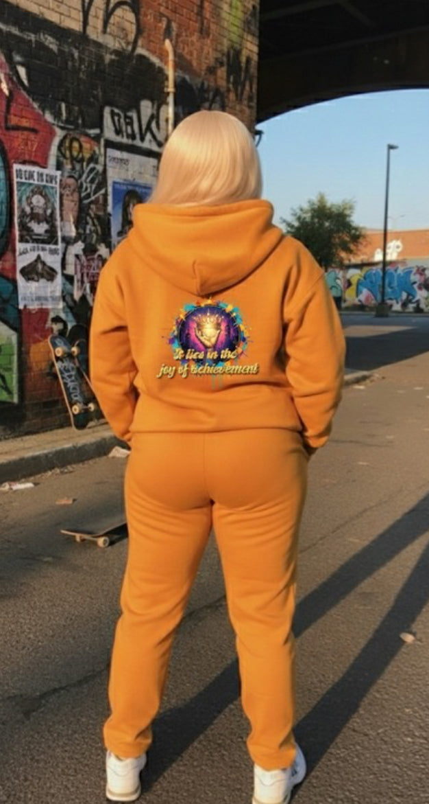 Joy of Achievement- HOODIE worn by a person in a vibrant urban setting, showcasing streetwear style and comfort.