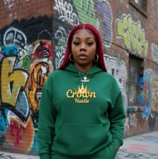 Value What You Know ￼- HOODIE worn by a model in a green Crown Hustle Fleece Pullover, showcasing streetwear style.