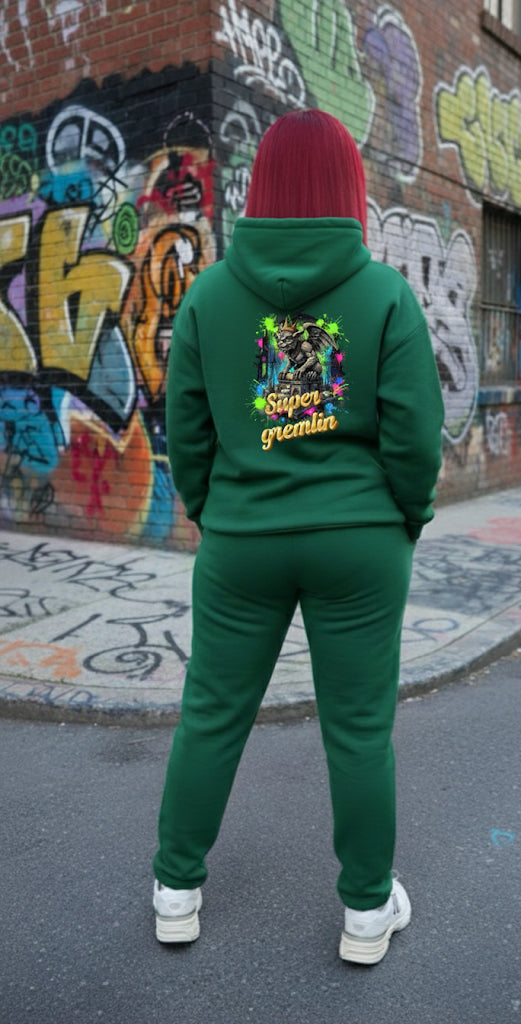 Back view of a model wearing a green Super Gremlin- HOODIE with vibrant graphic, showcasing streetwear style.